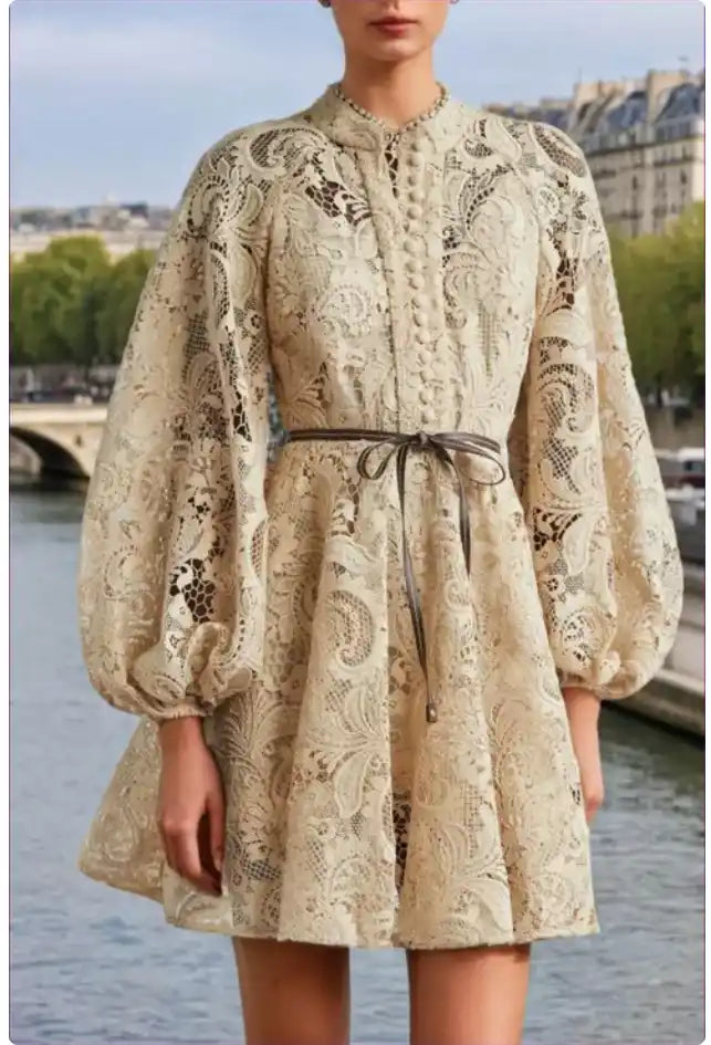 Cream-colored lace dress with balloon sleeves and a tied waist belt.