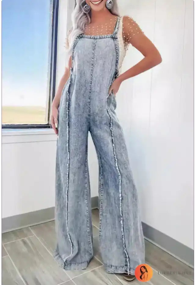 Light-wash denim overalls with wide-leg styling and square neckline.