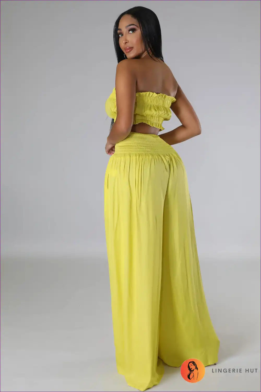 Capture Summer Elegance With Our Elegant Strapless Crop Top And High Rise Ruffle Pants Set. Exude Grace