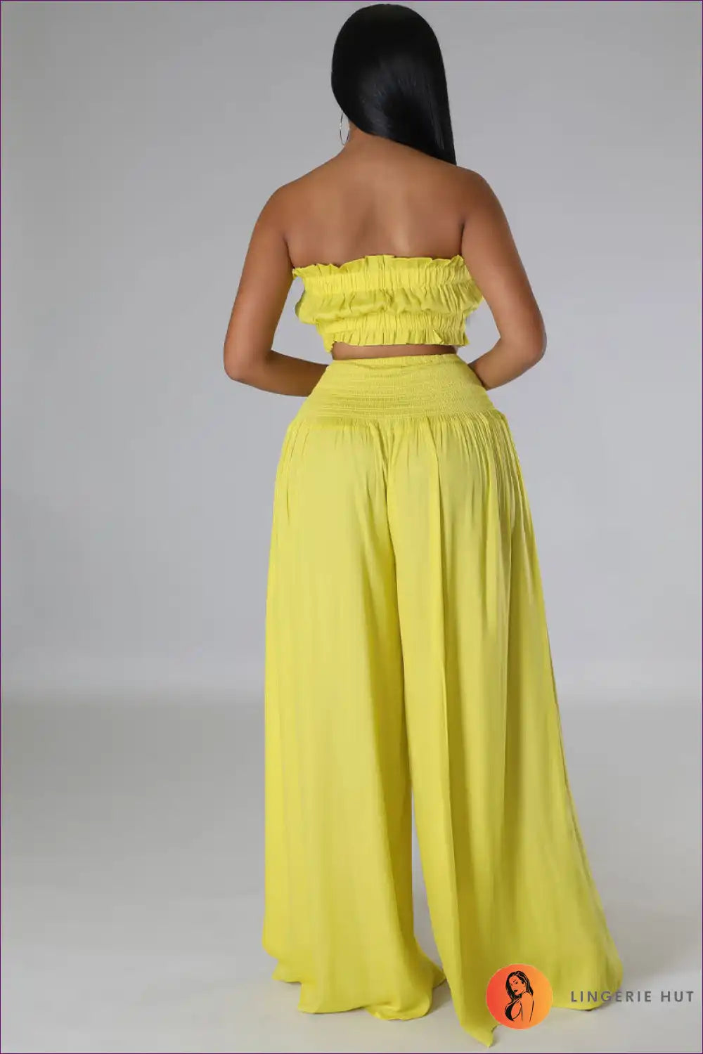 Capture Summer Elegance With Our Elegant Strapless Crop Top And High Rise Ruffle Pants Set. Exude Grace