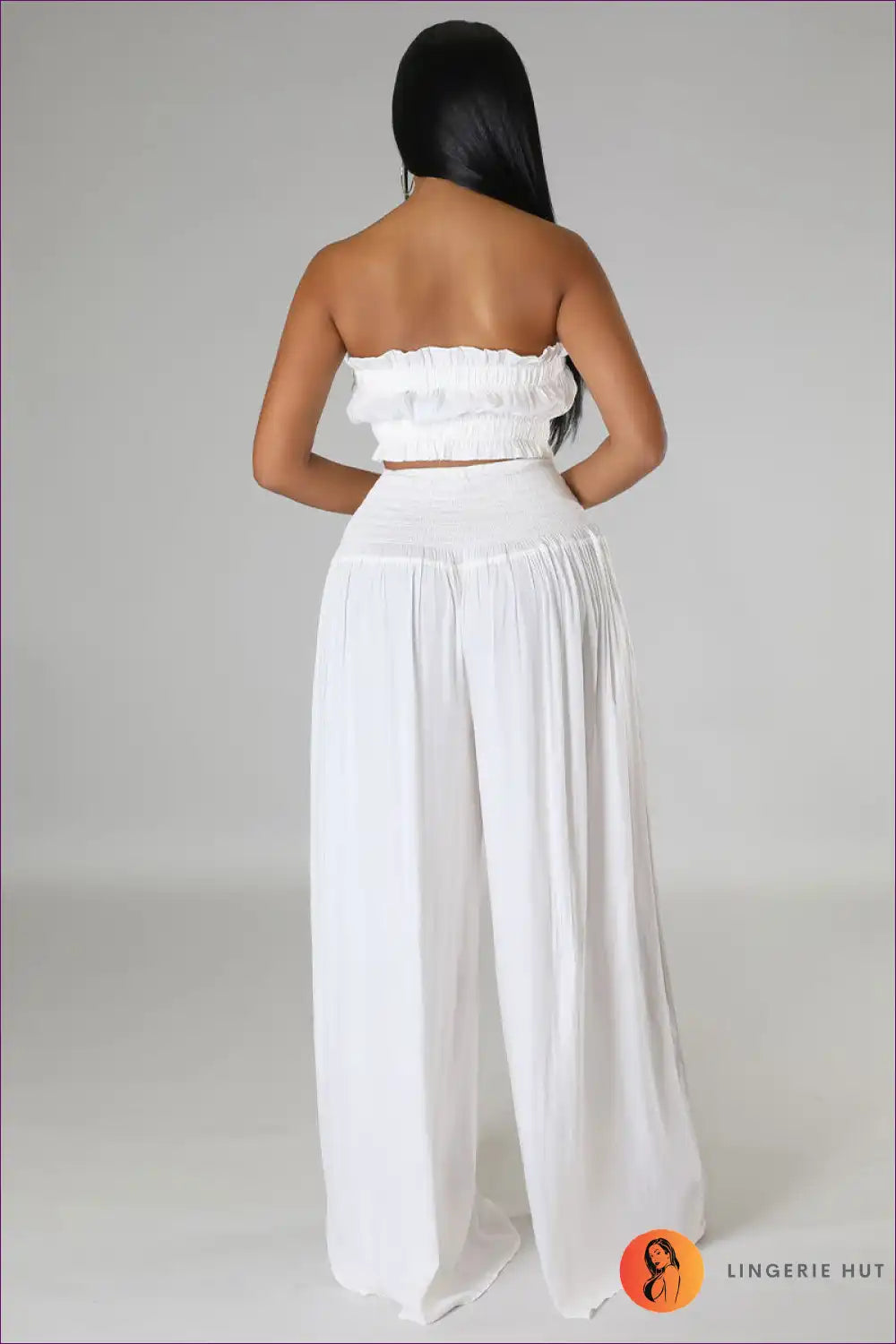 Capture Summer Elegance With Our Elegant Strapless Crop Top And High Rise Ruffle Pants Set. Exude Grace