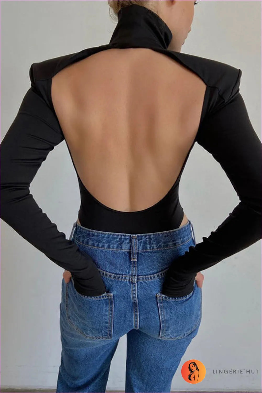 Turn Heads With Our Turtle Neck Backless Long Sleeve Thong Bodysuit. Figure-hugging, Ribbed Turtle Neck,