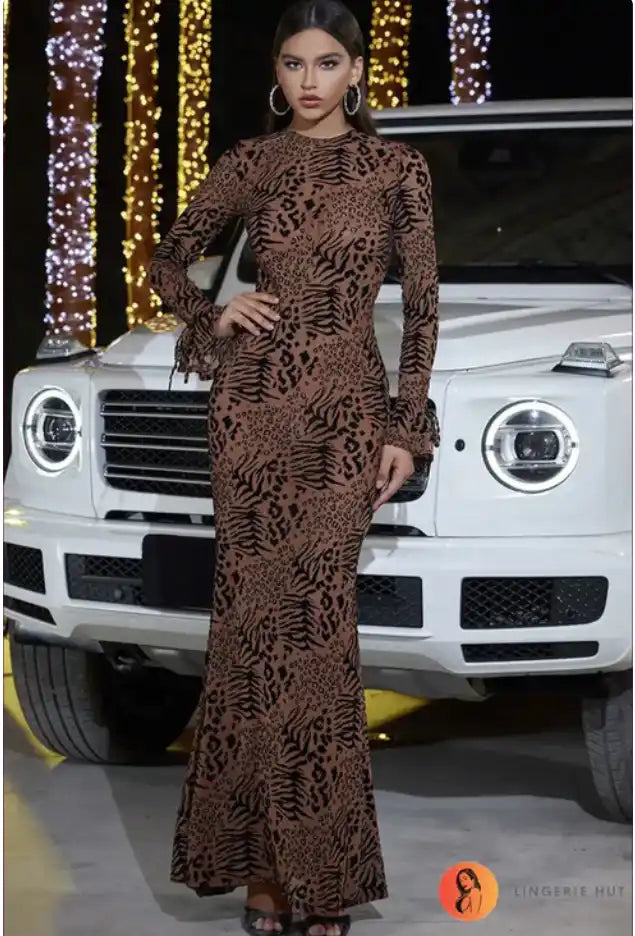 Long-sleeved brown lace evening gown with a fitted silhouette and full-length skirt.