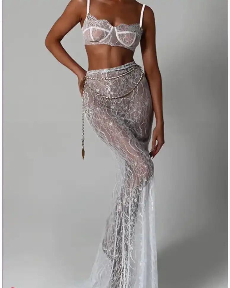 White lace two-piece lingerie set featuring a bralette and floor-length sheer skirt with intricate embroidered details.