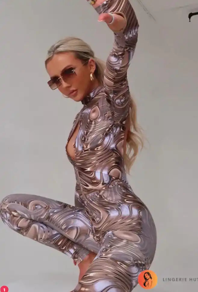 A woman wearing a form-fitting swirled metallic jumpsuit and sunglasses.